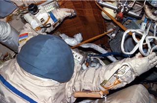 Views of the Mir space station airlock including Orlan suits. 